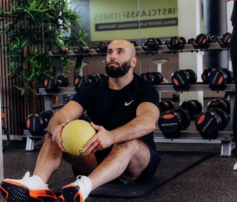 personal training, man with a beard and exercise ball in the studio